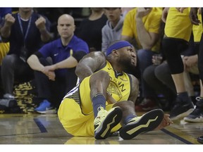 Golden State Warriors center DeMarcus Cousins reacts after falling to the floor during the first half of Game 2 of a first-round NBA basketball playoff series against the Los Angeles Clippers in Oakland, Calif., Monday, April 15, 2019.