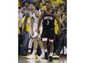 Golden State Warriors guard Klay Thompson, left, smiles as Houston Rockets guard Chris Paul (3) is ejected during the second half of Game 1 of a second-round NBA basketball playoff series in Oakland, Calif., Sunday, April 28, 2019.