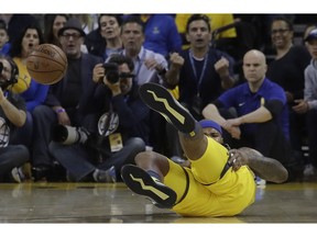 Golden State Warriors center DeMarcus Cousins reacts after falling to the floor during the first half of Game 2 of a first-round NBA basketball playoff series against the Los Angeles Clippers in Oakland, Calif., Monday, April 15, 2019.