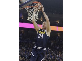 Denver Nuggets forward Mason Plumlee (24) dunks against the Golden State Warriors during the first half of an NBA basketball game in Oakland, Calif., Tuesday, April 2, 2019.