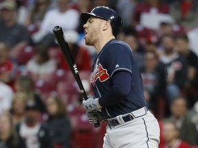 Atlanta Braves' Freddie Freeman reacts after being hit by a pitch from Cincinnati Reds starting pitcher Tanner Roark in the fifth inning of a baseball game, Wednesday, April 24, 2019, in Cincinnati.