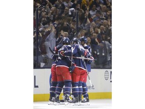 Columbus Blue Jackets players celebrate their goal against the Boston Bruins during the first period of Game 3 of an NHL hockey second-round playoff series Tuesday, April 30, 2019, in Columbus, Ohio.