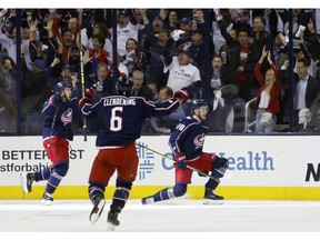 Columbus Blue Jackets' Pierre-Luc Dubois, right, celebrates his goal against the Tampa Bay Lightning with teammates Oliver Bjorkstrand, left, of Denmark, and Adam Clendening during the first period of Game 4 of an NHL hockey first-round playoff series, Tuesday, April 16, 2019, in Columbus, Ohio.