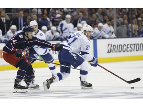 Tampa Bay Lightning's Brayden Point, right, looks for an open pass as Columbus Blue Jackets' Dean Kukan, of Switzerland, defends during the first period of Game 3 of an NHL hockey first-round playoff series Sunday, April 14, 2019, in Columbus, Ohio.