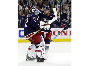 Columbus Blue Jackets' Sergei Bobrovsky, left, of Russia, and Brandon Dubinsky celebrate their win over the Tampa Bay Lightning in Game 4 of an NHL hockey first-round playoff series, Tuesday, April 16, 2019, in Columbus, Ohio. The Blue Jackets beat the Lightning 7-3.