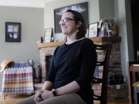 Mindy Nagel smiles as she is interviewed at her home, Monday, April 1, 2019, in Cincinnati. Mindy usually votes Democratic; while husband Tom usually goes Republican. But that's only part of it: their bedroom is in Ohio's 1st congressional district while their garage is in the 2nd.
