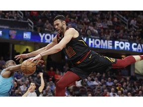 Cleveland Cavaliers' Larry Nance Jr., right, drives to the basket against Charlotte Hornets' Kemba Walker in the first half of an NBA basketball game, Tuesday, April 9, 2019, in Cleveland. Walker was called for a foul.