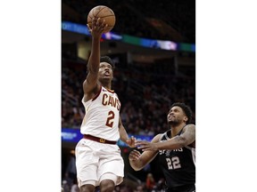 Cleveland Cavaliers' Collin Sexton (2) drives to the basket against San Antonio Spurs' Rudy Gay (22) in the first half of an NBA basketball game, Sunday, April 7, 2019, in Cleveland.