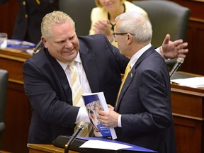 Ontario Finance Minister Vic Fedeli is congratulated by Premier Doug Ford after presenting the 2019 budget at the legislature in Toronto on Thursday, April 11, 2019.