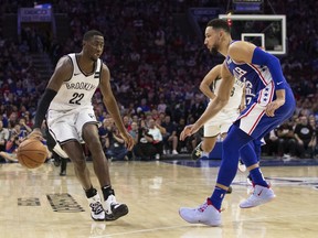 Brooklyn Nets' Caris LeVert, left, makes his move against Philadelphia 76ers' Ben Simmons, right, of Australia, during the second half in Game 5 of a first-round NBA basketball playoff series, Tuesday, April 23, 2019, in Philadelphia. The 76ers won 122-100.