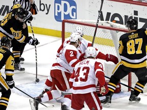 Pittsburgh Penguins' Phil Kessel (81) puts a rebound behind Detroit Red Wings goaltender Jimmy Howard for a goal during the first period of an NHL hockey game in Pittsburgh, Thursday, April 4, 2019.