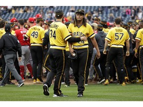 Pittsburgh Pirates starting pitcher Chris Archer (24) walks away from a bench clearing brawl with fellow pitcher Trevor Williams (34) during the fourth inning of a baseball game in Pittsburgh, Sunday, April 7, 2019. A wild pitch by Archer during an at-bat by Reds' Derek Dietrich started the fight.