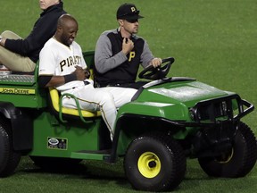 Pittsburgh Pirates center fielder Starling Marte is driven off the field after colliding with shortstop Erik Gonzalez while attempting to field a fly ball to short center by San Francisco Giants' Yangervis Solarte during the eighth inning of a baseball game in Pittsburgh, Friday, April 19, 2019. The Pirates won 4-1.