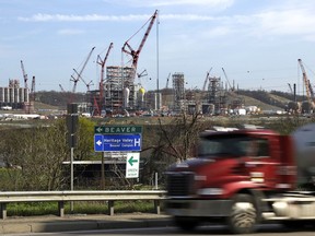 FILE - In this April 18, 2019 file photo a tanker truck passes a petrochemical plant being built on the banks of the Ohio River in Monaca, Pa., for the Royal Dutch Shell company. The plant, which is capable of producing 1.6 million tons of raw plastic annually, is expected to begin operations by 2021.