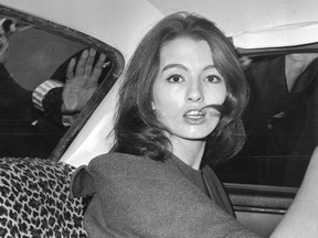 FILE - In this July 22, 1963 file photo, Christine Keeler is photographed during a vice charges case against osteopath Dr. Stephen Ward. The model had been having an affair with Cabinet member John Profumo at the same time as having a liaison with a Russian naval attache. The scandal rocked the political establishment. It was one of the great postwar crises in Britain, the latest of which relates to the country's struggles to leave the European Union. (AP Photo/File)