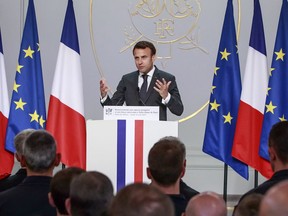 French President Emmanuel Macron addresses Paris Firefighters' brigade and security forces who took part at the fire extinguishing operations of the Notre Dame of Paris Cathedral fire, at the Elysee Palace in Paris, Thursday, April 18, 2019. France paid a daylong tribute Thursday to the Paris firefighters who saved the internationally revered Notre Dame Cathedral from collapse and rescued many of its treasures.