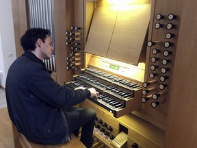Vincent Dubois, organist at the Great Organ of Notre-Dame de Paris, plays the organ at Strasbourg Conservatoire (music school), eastern France, Wednesday April 17, 2019. Dubois, who wasn't in the cathedral, says the instrument "must be completely dusted off, cleaned from the soot, the dust that is inside."