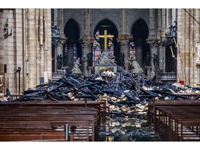 A hole is seen in the dome inside Notre Dame cathedral in Paris, Tuesday, April 16, 2019. Firefighters declared success Tuesday in a more than 12-hour battle to extinguish an inferno engulfing Paris' iconic Notre Dame cathedral that claimed its spire and roof, but spared its bell towers and the purported Crown of Christ.