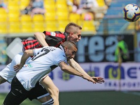 Parma's Antonino Barilla', bottom, and AC Milan's Andrea Conti vie for the ball during a Serie A soccer match between Parma and AC Milan at the Ennio Tardini Stadium in Parma, Italy, Saturday, April 20, 2019.