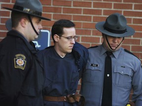 FILE - In this Jan. 5, 2015, file photo, Eric Frein is led away by Pennsylvania State Police Troopers at the Pike County Courthouse after his preliminary hearing in Milford, Pa. On Friday April 26, 2019, Pennsylvania's highest court uphold the death sentence and conviction of Frein who killed Pennsylvania state trooper Cpl. Bryon Dickson II and wounded another outside their barracks.