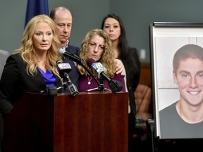 FILE - In this May 5, 2017 file photo, Jim and Evelyn Piazza stand by as Centre County District Attorney Stacy Parks Miller, left, announces the results of an investigation into the death of their son Timothy Piazza, seen in photo at right, a Penn State University fraternity pledge, during a press conference in Bellefonte, Pa.   Three ex-Penn State fraternity brothers have been sentenced to jail on hazing charges in connection to the February 2017 death of Piazza.  Sentences handed down Tuesday, April 2, 2019,  to the three former Beta Theta Pi members range from 30 days to three months in jail.