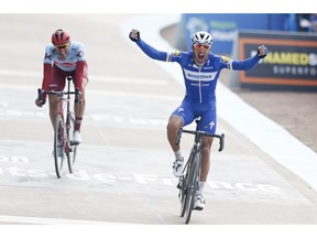 Philippe Gilbert of Belgium celebrates as he crosses the finish line ahead of Nils Politt of Germany, left, to win the 117th edition of the Paris-Roubaix cycling classic, a 257 kilometer (160 mile) one-day-race, with about 20 per cent of the distance over cobblestone roads, at the velodrome in Roubaix, northern France, Sunday, April 14, 2019.
