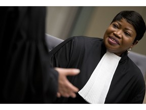 -FILE- In this Wednesday, April 4, 2018 image, chief prosecutor Fatou Bensouda waits for alleged jihadist leader Al Hassan Ag Abdoul Aziz Ag Mohamed Ag Mahmoud to enter the court room at the International Criminal Court in The Hague, Netherlands. Judges at the International Criminal Court have rejected a request by the court's prosecutor to open an investigation into war crimes and crimes against humanity in Afghanistan and alleged crimes by U.S. forces linked to the conflict. In a decision Friday, judges said an investigation "would not serve the interests of justice" because an investigation and prosecution are unlikely to be successful because of a lack of cooperation.