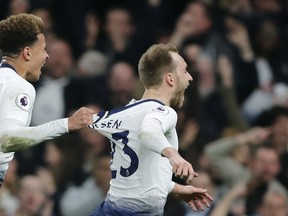 Tottenham's Christian Eriksen, center, celebrates with Tottenham's Dele Alli after Eriksen scored his side's first goal during the English Premier League soccer match between Tottenham Hotspur and Brighton & Hove Albion at Tottenham Hotspur stadium in London, Tuesday, April 23, 2019.