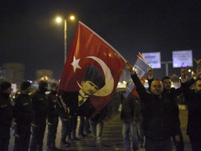 Supporters of the Republican People's Party, CHP, wave a flag with a portrait of Kemal Ataturk as they celebrate after preliminary results of the local elections were announced in Ankara, Turkey, early Monday, April 1, 2019. Erdogan's ruling party has declared victory in the race for mayor of Istanbul, even though the result in Turkey's most populous city and commercial hub is too close to call. State broadcaster TRT says former Prime Minister Binali Yildirim received 48.71 percent of the votes in Sunday's municipal elections while the opposition's candidate, Ekrem Imamoglu, got 48.65 percent.