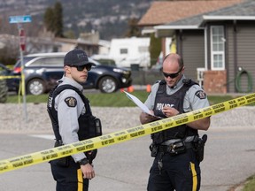 RCMP officers work outside a crime scene in Penticton, B.C., on Monday April 15, 2019.