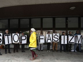 Protesters hold a banner outside the Supreme Court in Bratislava, Slovakia, Monday, April 29, 2019. The Supreme Court is considering a request from the Prosecutor General to ban parliamentary far-right party People's Party Our Slovakia. The banner reads: "Stop Fascism".
