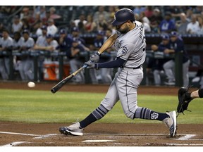San Diego Padres' Eric Hosmer connects for a two-run single against the Arizona Diamondbacks during the first inning of a baseball game Saturday, April 13, 2019, in Phoenix.
