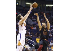 Cleveland Cavaliers forward Larry Nance Jr. (22) shoots over Phoenix Suns forward Dragan Bender, left, during the first half of an NBA basketball game Monday, April 1, 2019, in Phoenix.