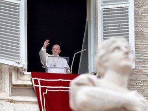 Pope Francis waves to the crowd from the window of the apostolic palace overlooking St Peter's square during the Regina Coeli prayer, on April 28, 2019 in Vatican.