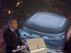 Real Madrid's President Florentino Perez makes a speech in front of an artist's image of the proposed new Santiago Bernabeu stadium during a presentation to remodel the stadium in Madrid, Spain, Tuesday, April 2, 2019.