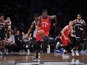 Toronto Raptors forward Pascal Siakam, center, dribbles the ball down court during the first half of an NBA basketball game Wednesday, April 3, 2019, in New York.
