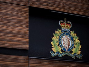 The RCMP logo is seen outside Royal Canadian Mounted Police "E" Division Headquarters, in Surrey, B.C., on Friday April 13, 2018. An Inuit family whose son was shot by RCMP is suing the force over its failure to staff Arctic detachments with officers who can speak with and understand their posted communities.