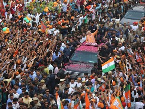 Indian Prime Minister Narendra Modi waves to the crowd during a political campaign road show in Varanasi, India, Thursday, April 25, 2019. The ongoing general election is seen as a referendum on Modi's five-year rule. He has adopted a nationalist pitch in trying to win votes from the country's Hindu majority by projecting a tough stance against Pakistan, India's Muslim-majority neighbor and archrival.