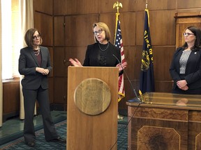 Oregon attorney general Ellen Rosenblum, center, hails a ruling by a federal judge in Oregon that blocks the Trump administration's attempt to prevent federally funded healthcare providers from referring pregnant women to abortion clinics, at a news conference in Salem, Ore. Oregon Gov. Kate Brown is at left, with Lisa Gardner, president of Planned Parenthood of Southwestern Oregon, at right.