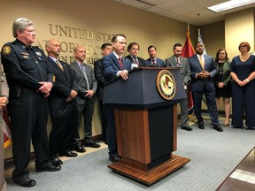 U.S. Attorney for the Western District of Tennessee Michael Dunavant (at podium) speaks at a news conference discussing charges of illegally distributing opioids and other prescription painkillers filed against more than 30 medical professionals in Tennessee on Thursday, April 18, 2019 in Memphis, Tenn.