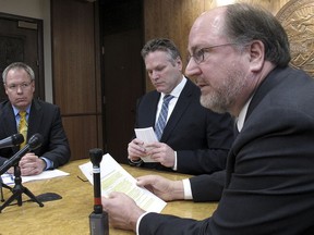 This photo from Jan. 30, 2019, shows Attorney General Kevin Clarkson, right, during a news conference with state Revenue Commissioner Bruce Tangeman, left, and Gov. Mike Dunleavy, center, in Juneau, Alaska. A state Department of Law spokeswoman said Clarkson was doing well after suffering a heart attack.