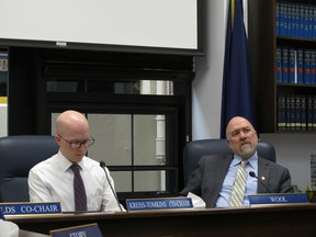 Alaska state Rep. Adam Wool, right, listens to testimony given by phone on the nomination of Amanda Price to be state Public Safety commissioner on Thursday, April 11, 2019, in Juneau, Alaska. Also shown is Rep. Jonathan Kreiss-Tomkins.