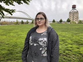 In this Monday, April 15, 2019, photo Elizabeth Graves, a 27-year-old resident of Portland, Ore., who was in foster care for more than five years, poses for a photo in a Portland, Ore., park. Children that are still under the care of Oregon's foster care system filed a lawsuit Tuesday, April 16, alleging the state exposed them to abuse and further neglect. Graves is not a plaintiff, but she says she was shuffled through 15 foster care families between the ages of 13 and 18 and many of the allegations in the lawsuit bring back bad memories for her.