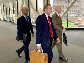 Former Minneapolis police officer Mohamed Noor, left, arrived with his defense attorneys Peter Wold, center, and Thomas Plunkett, right, on April 17, 2019, before another day of testimony in Noor's murder and manslaughter trial in Minneapolis. Noor is accused of fatally shooting an unarmed woman, Justine Ruszczyk Damond, on July 15, 2017, after she called 911 to report a possible sexual assault near her home.