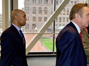 Former Minneapolis police officer Mohamed Noor, left, arrived with his defense attorneys Peter Wold, center, and Thomas Plunkett, right, partially hidden, on April 17, 2019, before another day of testimony in Noor's murder and manslaughter trial in Minneapolis. Noor is accused of fatally shooting an unarmed woman, Justine Ruszczyk Damond, on July 15, 2017, after she called 911 to report a possible sexual assault near her home.