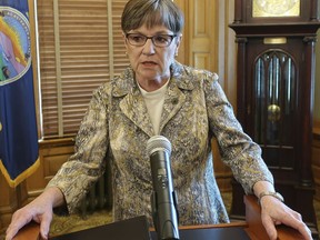 Kansas Gov. Laura Kelly speaks to reporters, Monday, April 22, 2019, at the Statehouse in Topeka, Kansas. Kelly has vetoed a bill that would require clinics to tell patients that a medication abortion can be stopped after they take the first of two pills.