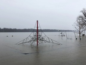 In this April 5, 2019, photo, a playground is submerged in floodwaters in Clarksville, Mo. Clarksville is recovering from its seventh major flood in a decade. Once again, a wall made of sandbags and rocks was hurriedly built to protect the quaint downtown, but with potentially worse flooding still to come this spring, Clarksville could face more danger.