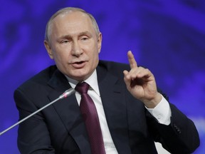 Russian President Vladimir Putin gestures while speaking at a plenary session of the International Arctic Forum in St. Petersburg, Russia, Tuesday, April 9, 2019.