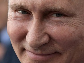 Russian President Vladimir Putin smiles as he visits the Kaliningrad Stadium after the 2018 soccer World Cup in Kaliningrad, Russia, Friday, July 20, 2018.