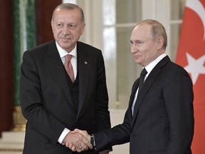 Russian President Vladimir Putin, right, shakes hands with Turkish President Recep Tayyip Erdogan after a joint news conference following their talks in the Kremlin in Moscow, Russia, Monday, April 8, 2019.